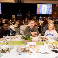 seven people at luncheon table
